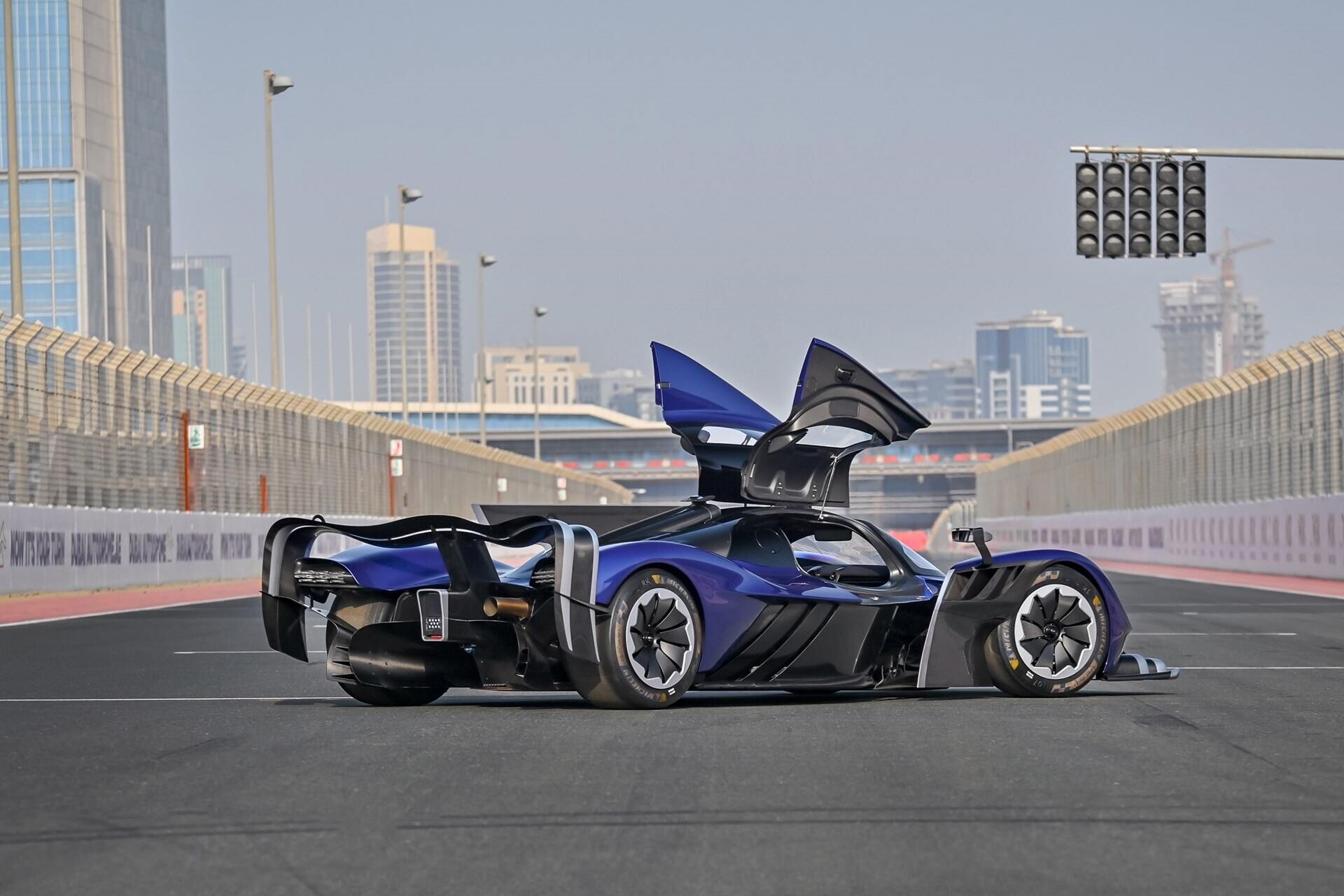 rear angled view of a blue 2022 Aston Martin Valkyrie AMR Pro with doors open