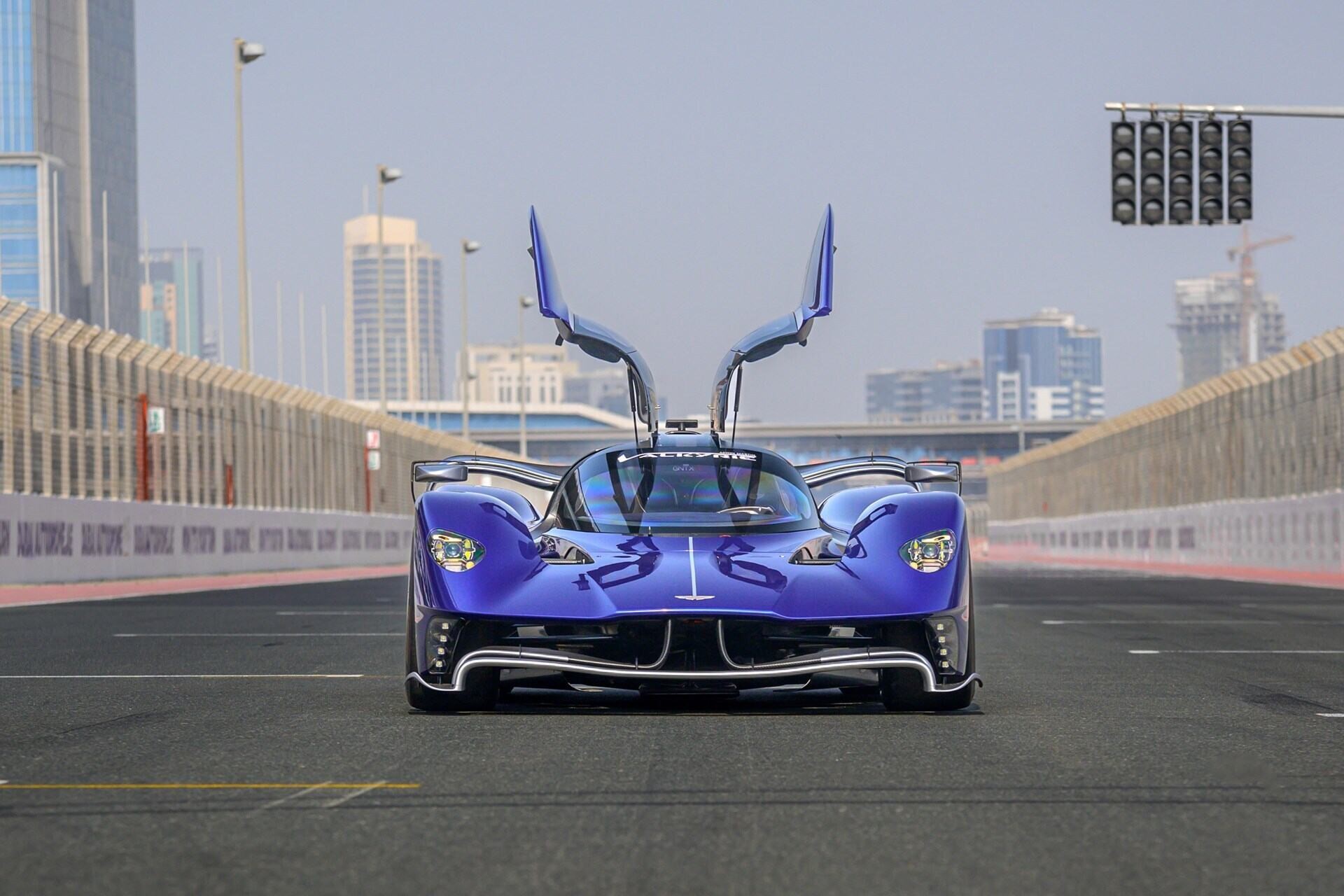 Frontal view of a blue 2022 Aston Martin Valkyrie AMR Pro with doors open.