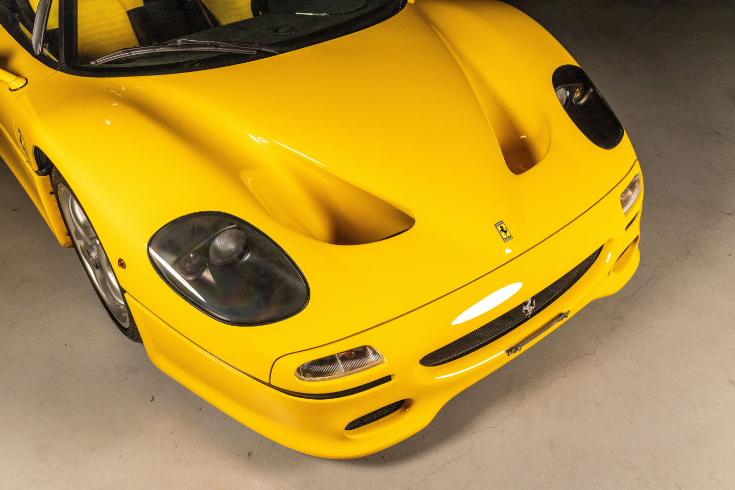 Aerial view of the front of a yellow Ferrari F50