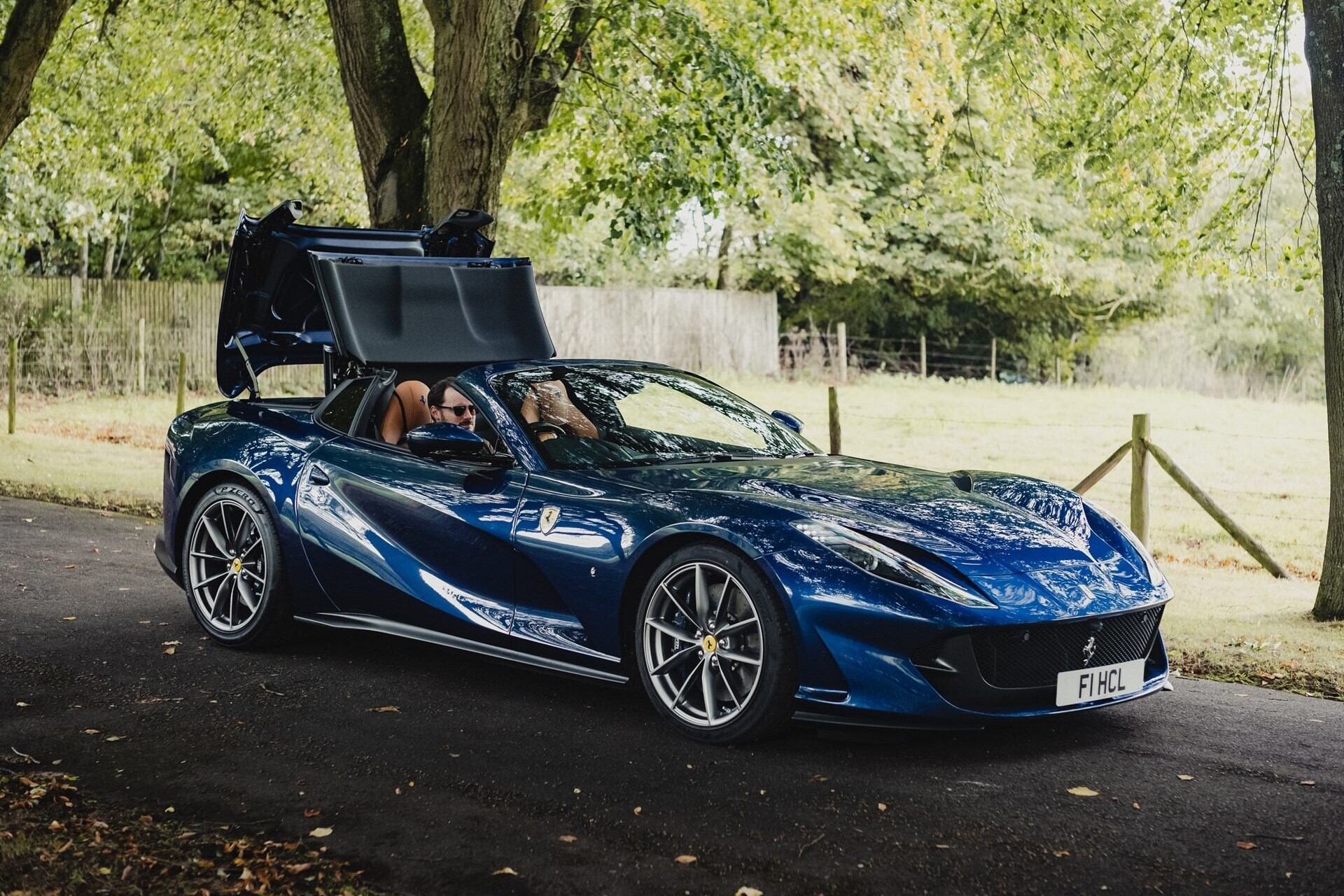 Image of a blue 2020 Ferrari 812 GTS with a partially opened top