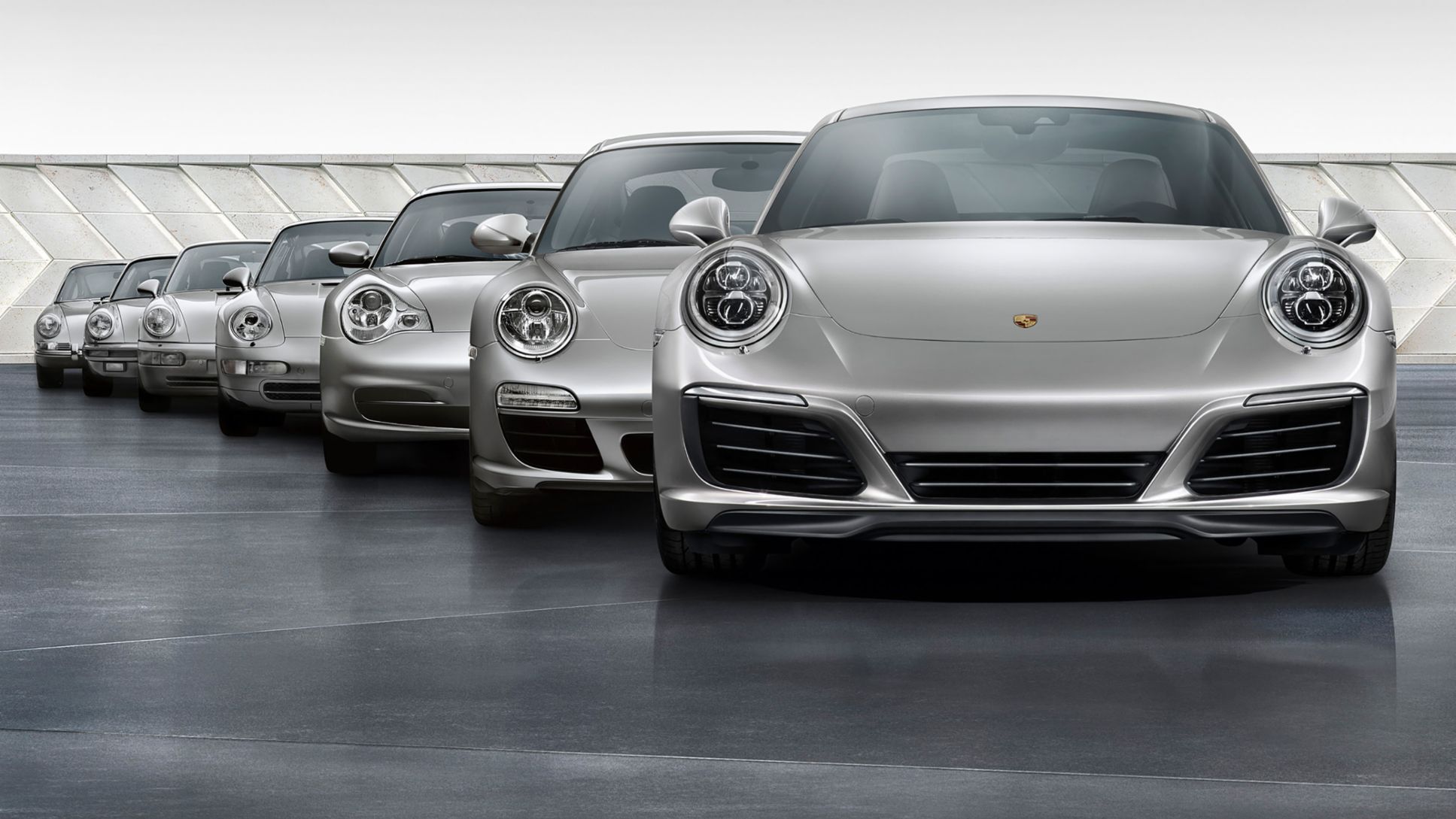 Image showing the partial frontal views of seven Porsche 911 generations.