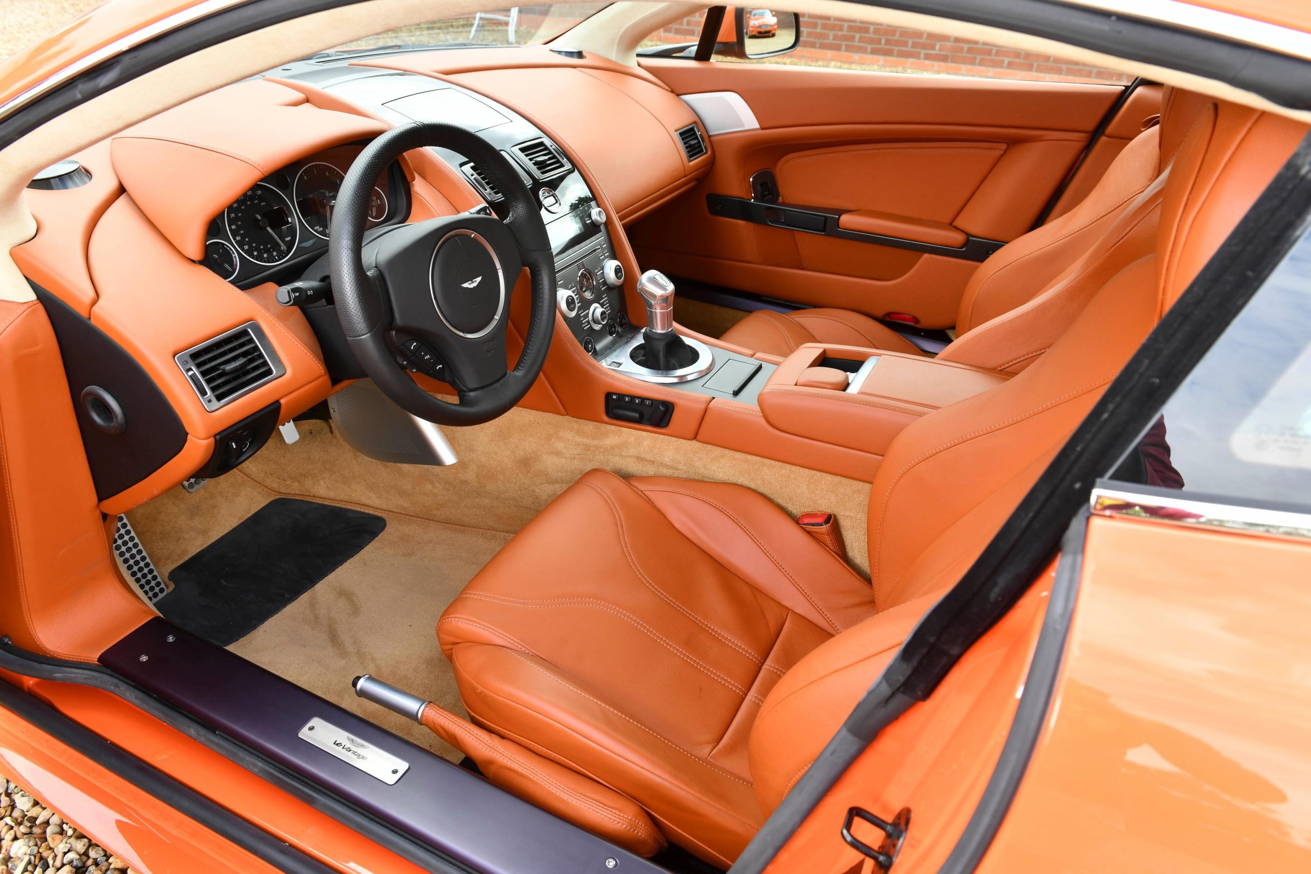 Interior of an orange Aston Martin V12 Vantage