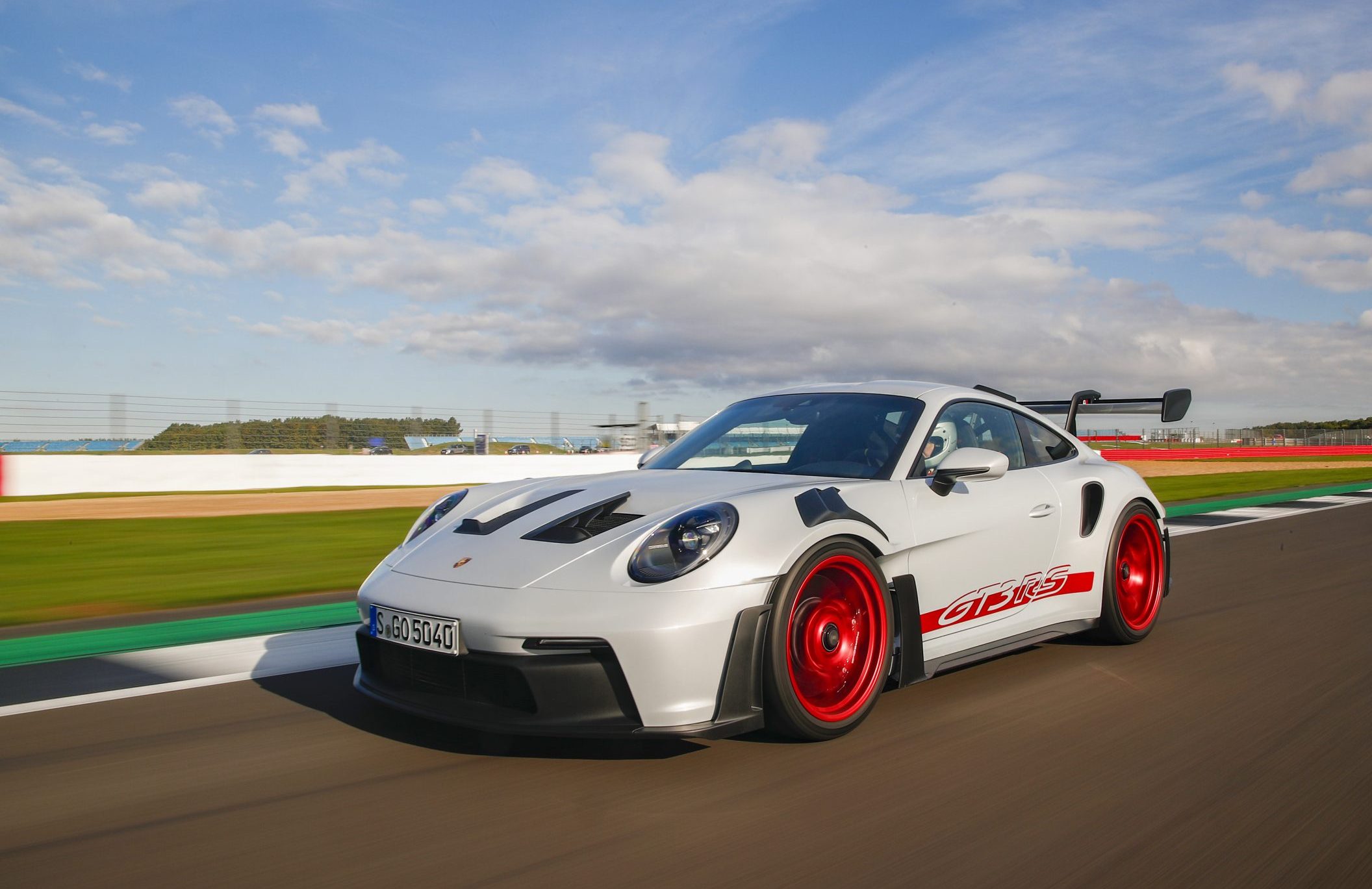 Three-quarter front view of a Porsche 911 GT3 RS on a racetrack