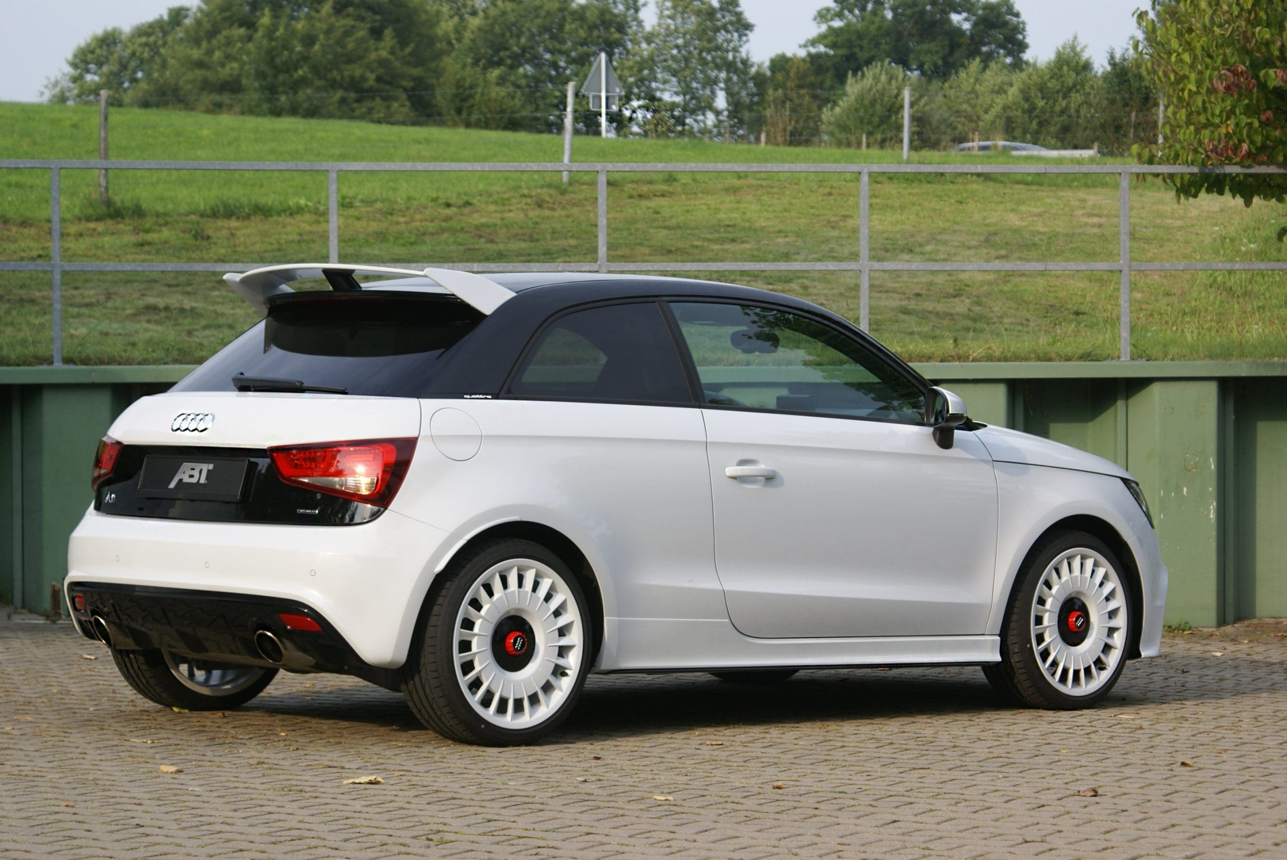 Three-quarter rear view of a white Audi 8X A1 Quattro