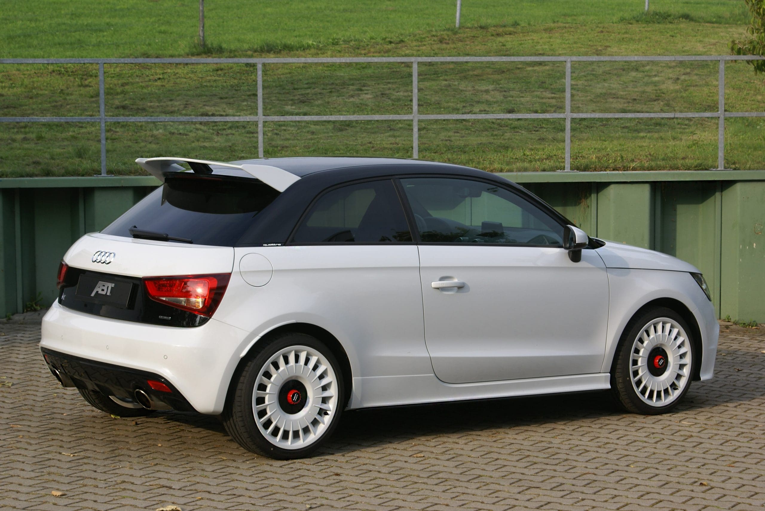 Three-quarter rear view of a white Audi 8X A1 Quattro