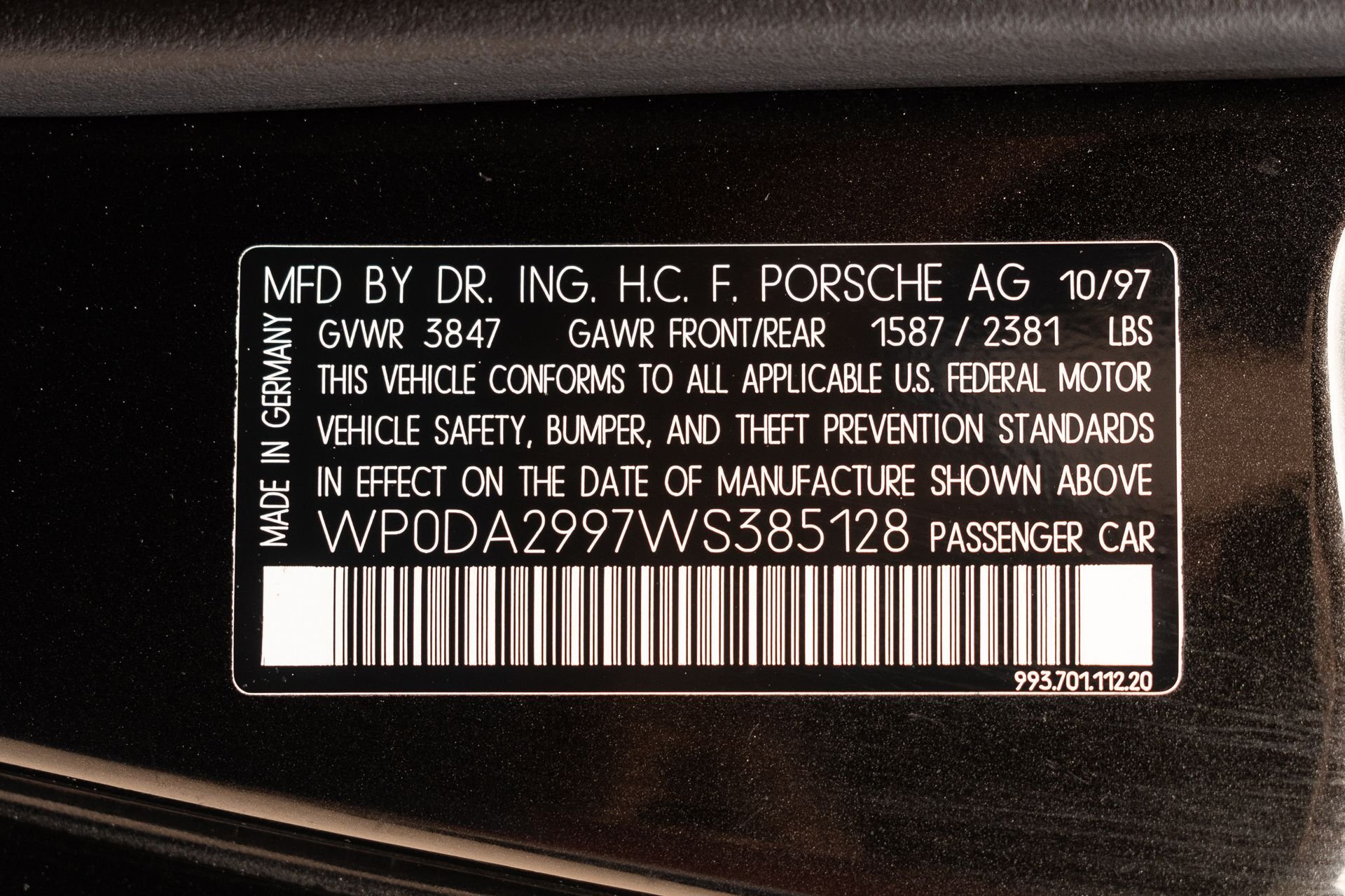 VIN plate on a 1998 Porsche 993 showing vehicle identification number and manufacturing details