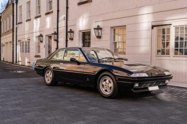 3/4 front view of a 1988 black Ferrari 412
